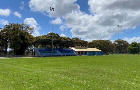 A photo of a small grandstand and playing field